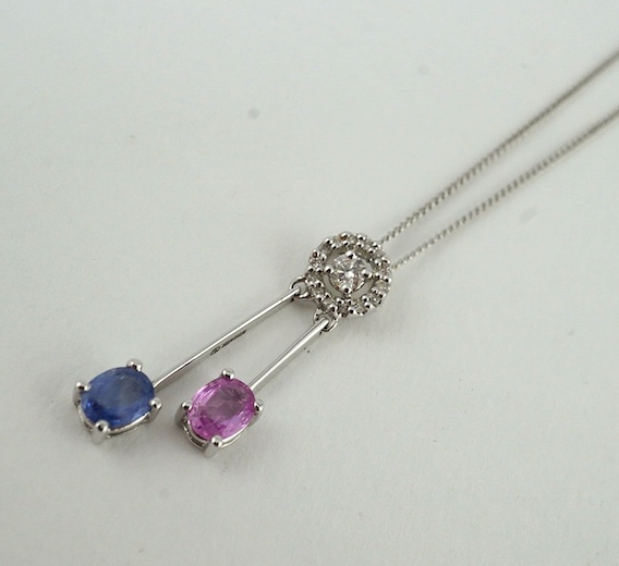 A modern 18k, two colour sapphire and diamond set double drop pendant, 26mm, on a 9ct white gold chain, 38cm, gross weight 2.5 grams. Condition - good